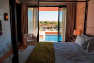 a bedroom with a view of a pool
