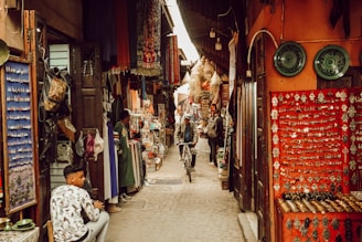 a man riding a bike down a narrow alley way