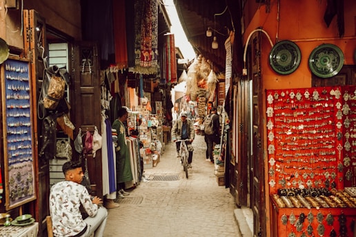 a man riding a bike down a narrow alley way