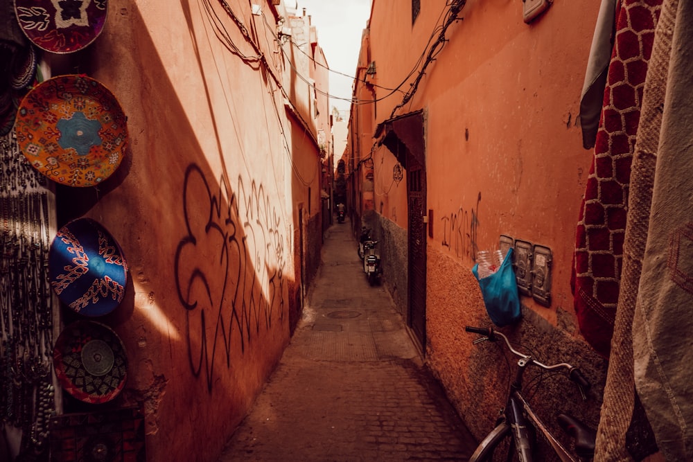 a narrow alley with a bicycle parked on the side