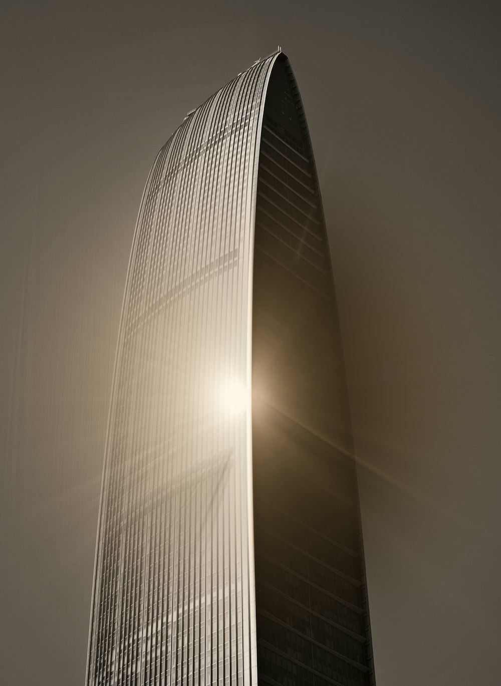 a very tall building with the sun shining through it