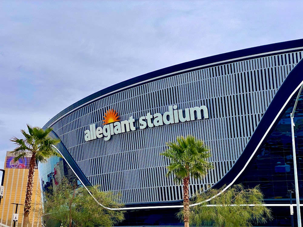 a large building with palm trees in front of it