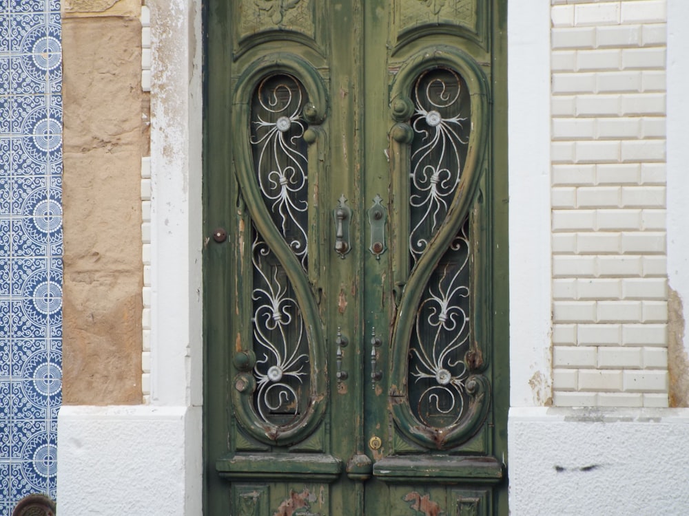 a close up of a green door on a building