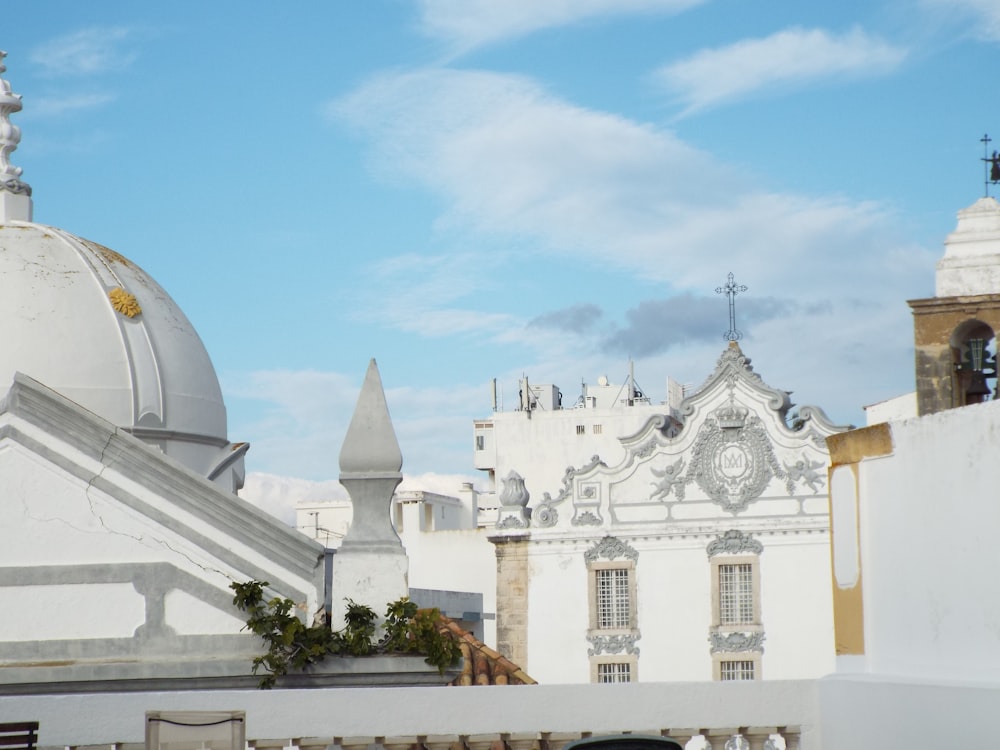 a white building with a clock on the top of it