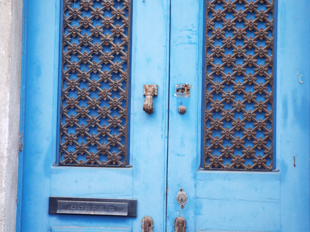 a close up of a blue door with a clock on it