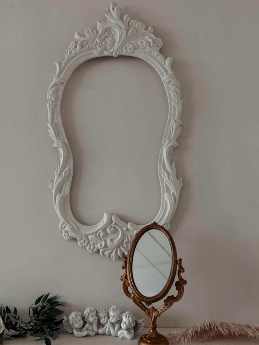 a mirror sitting on top of a table next to a plant