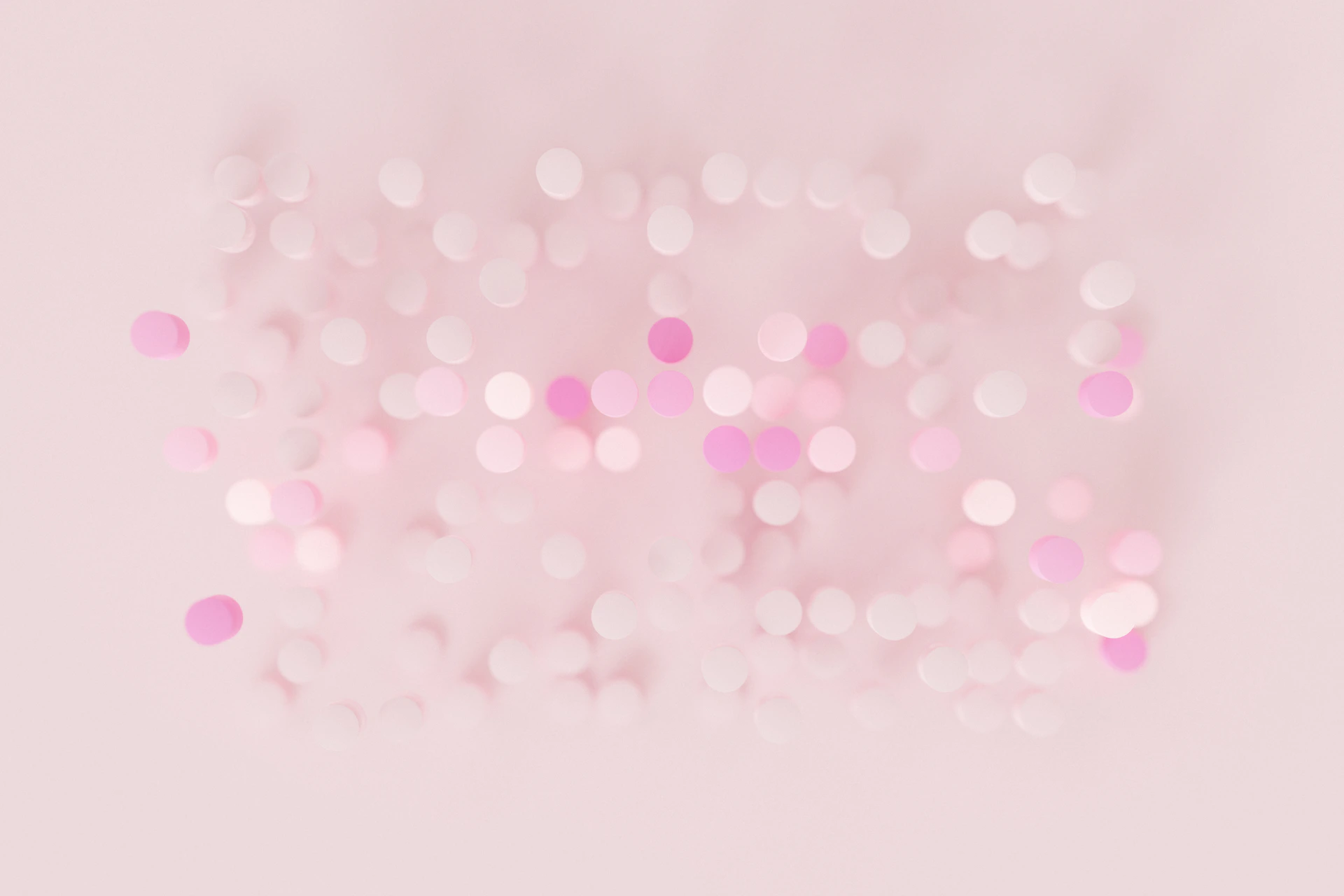 a blurry photo of pink and white circles