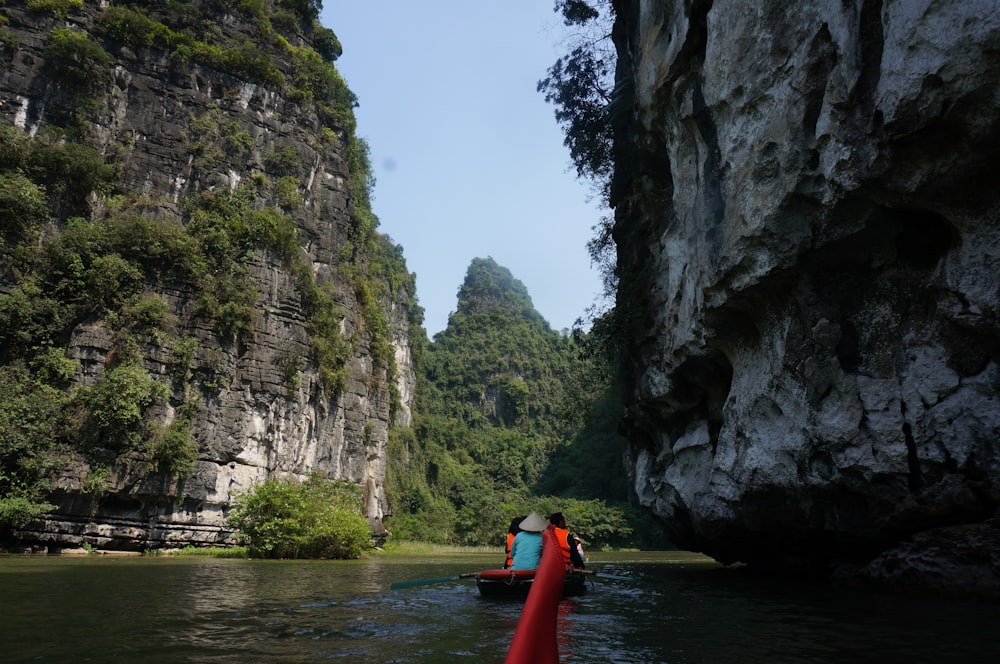 a person in a red boat on a river