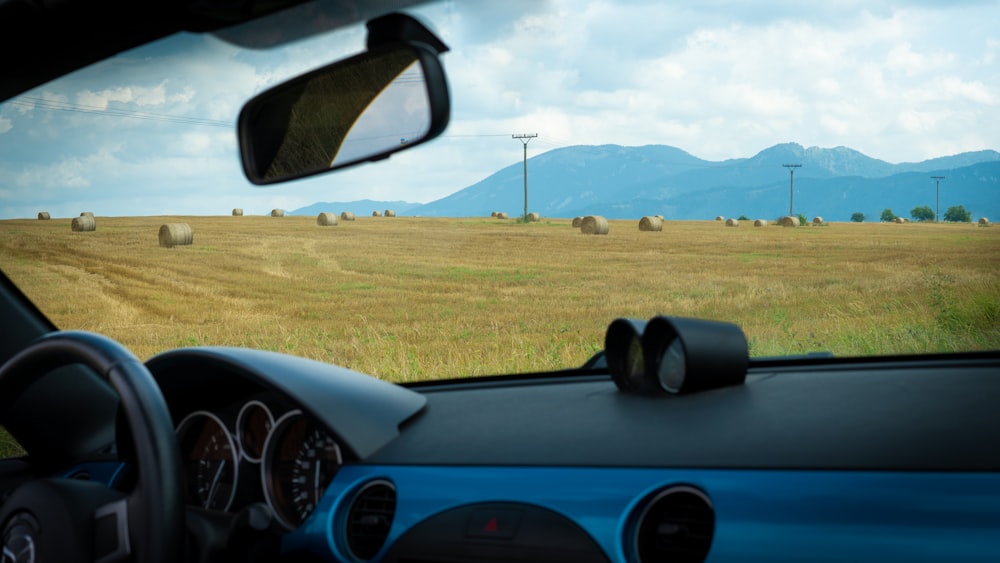 a view of a field from inside a car