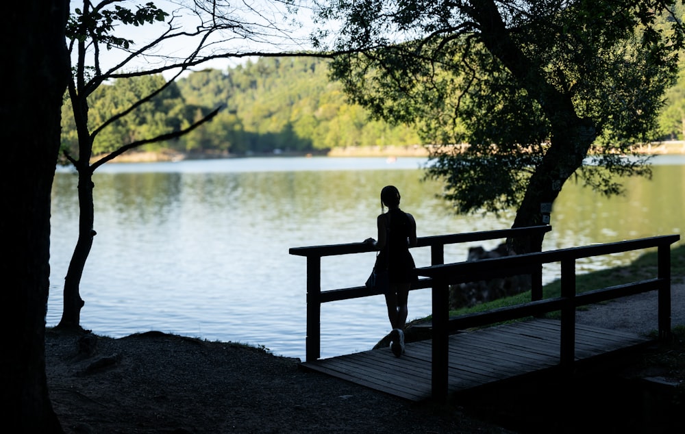 a person sitting on a bench near a body of water