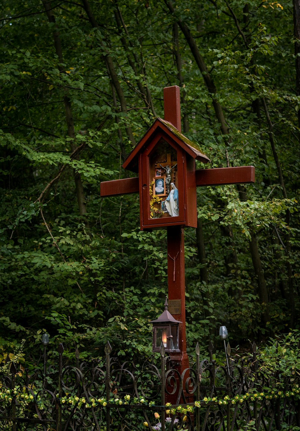 a wooden cross with a picture of people on it