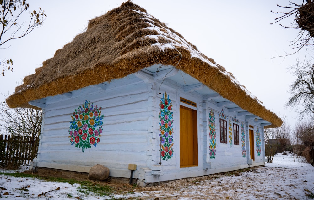 a small white house with a thatched roof