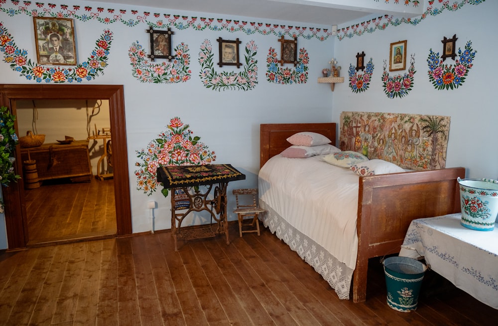 a bed room with a neatly made bed and a table