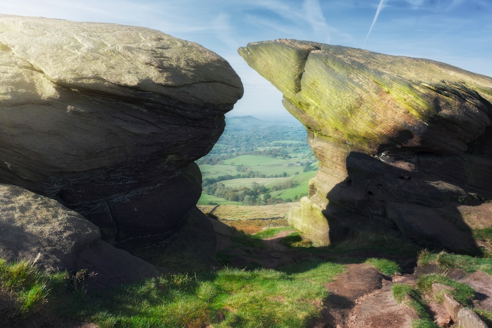 a large rock formation in the middle of a field