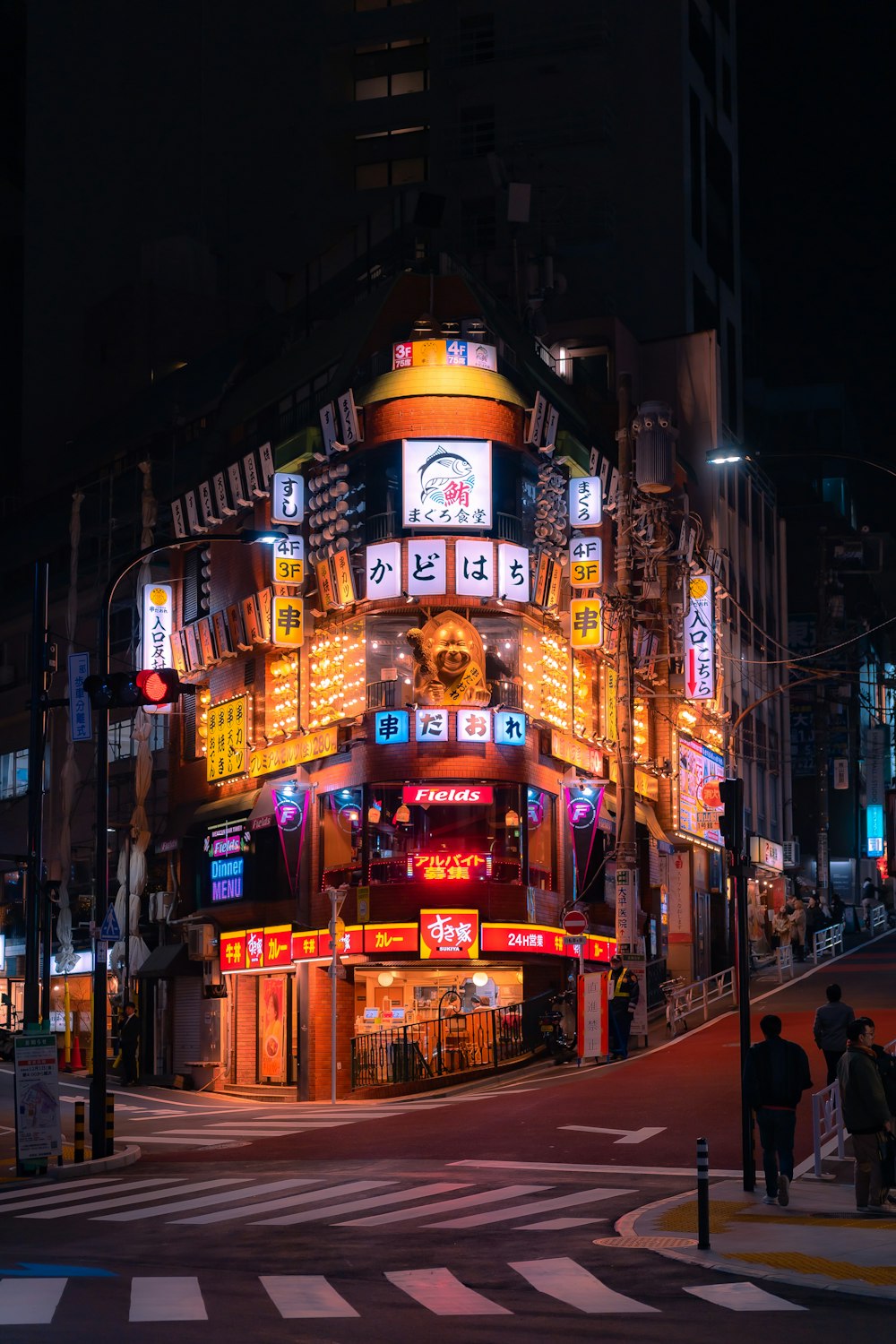 a city street at night with a lit up building