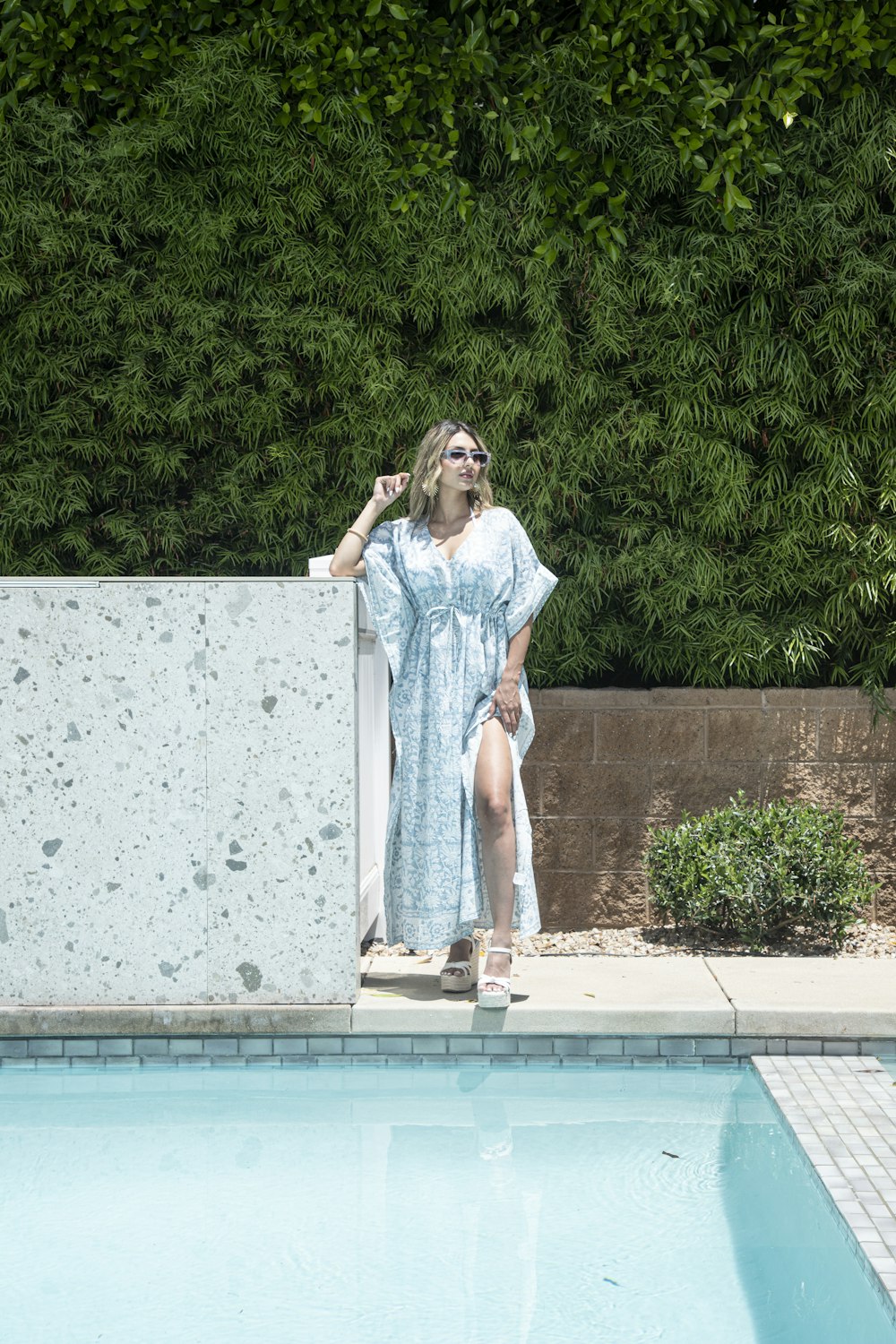 una donna in piedi accanto a una piscina