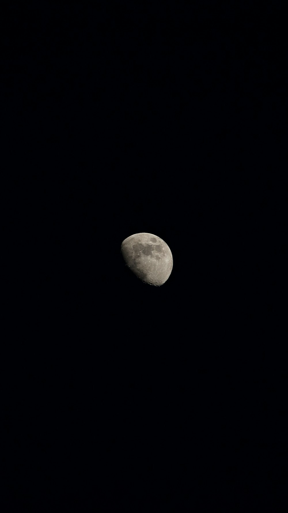 a full moon is seen in the dark sky