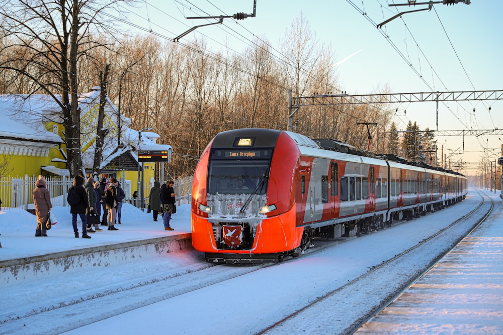 a red and white train traveling down train tracks