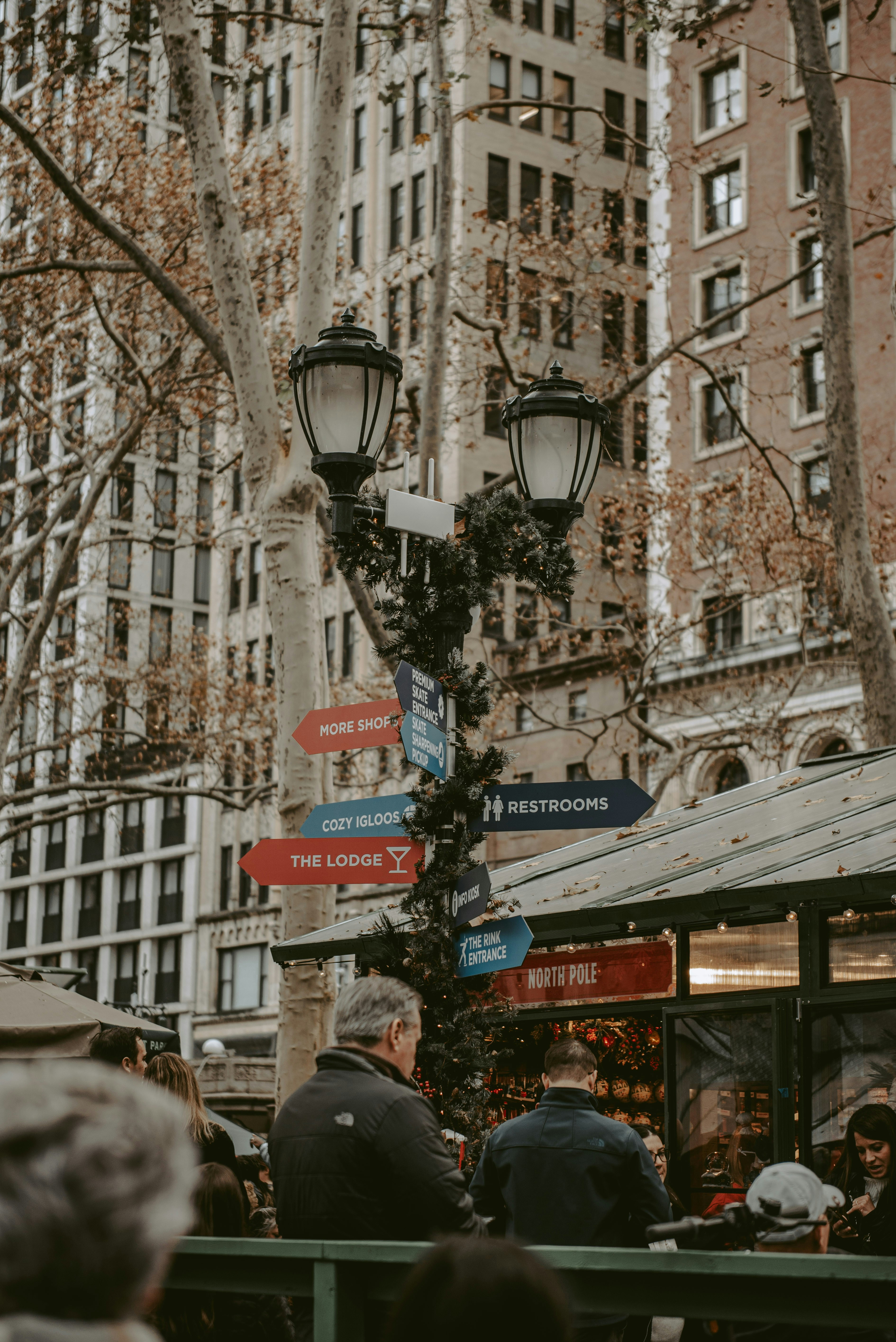 a group of people walking down a street next to a tall building