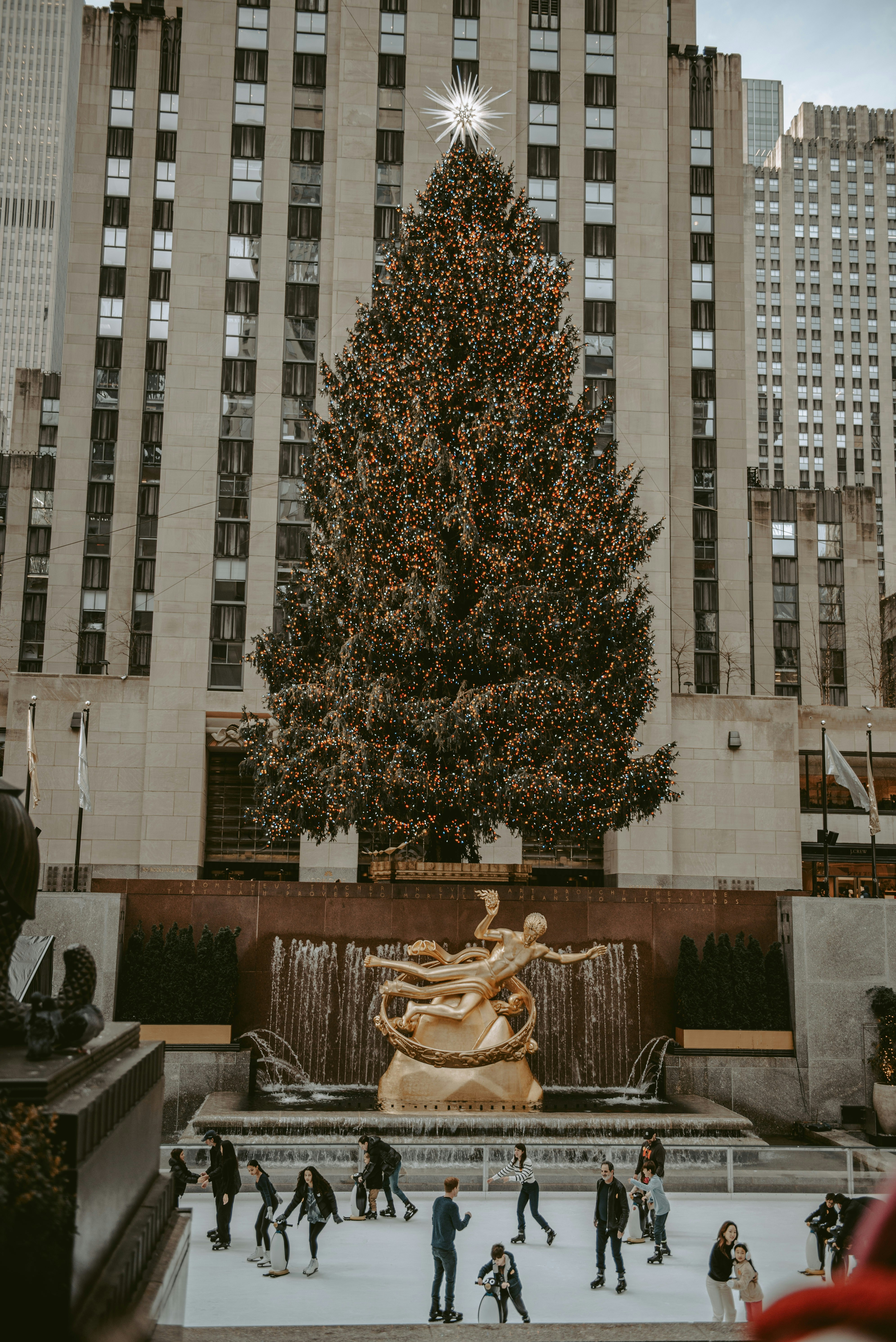 a large christmas tree in front of a building