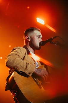 a man with a beard playing a guitar