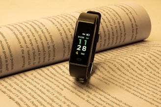a smart watch sitting on top of an open book