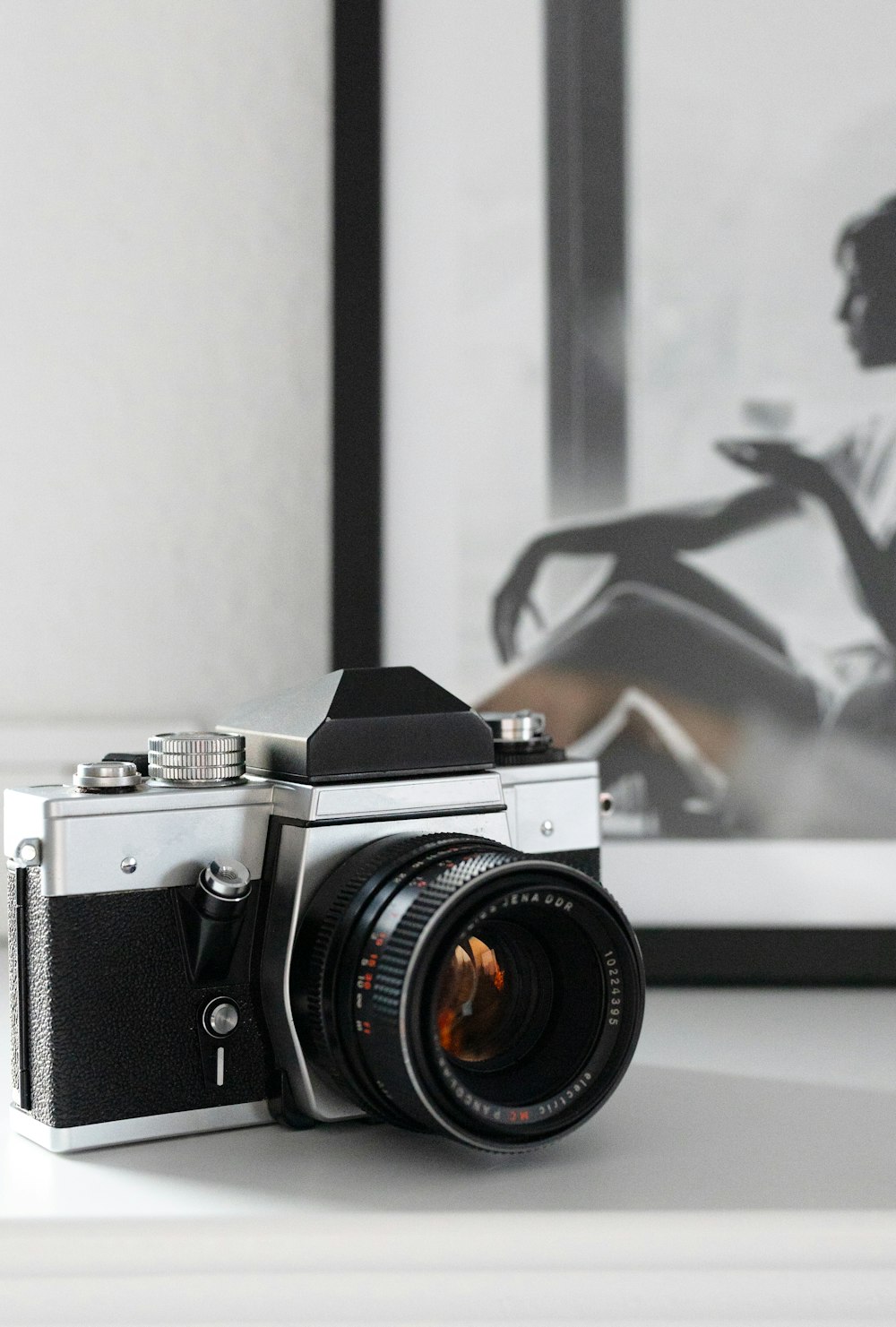 a camera sitting on top of a table next to a picture