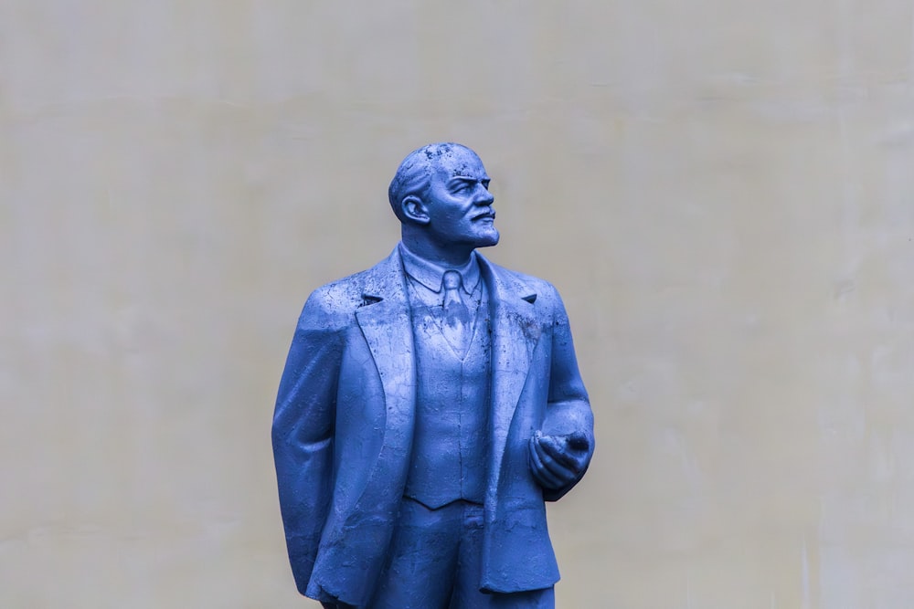 a blue statue of a man in a suit