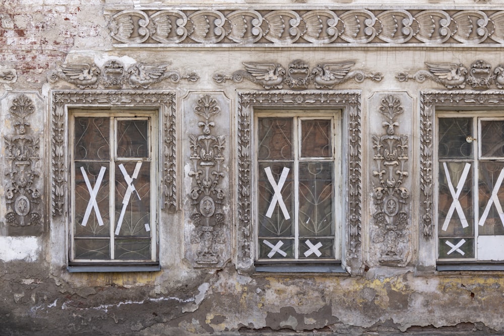 a building with three windows and a sign on the side of it