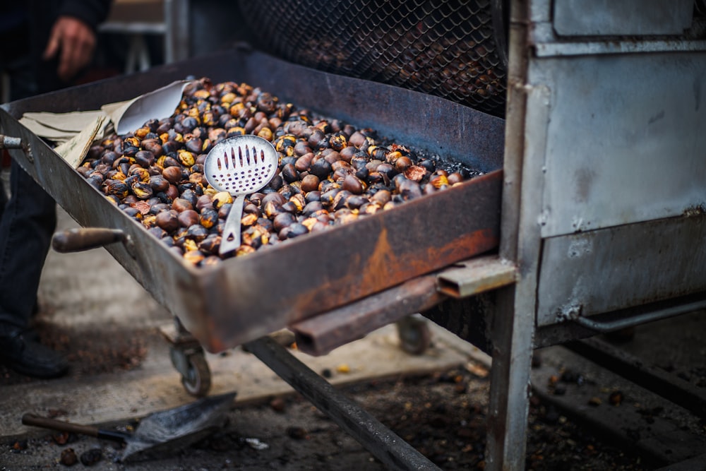 a large metal container filled with lots of nuts