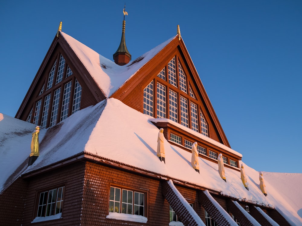 a church with a steeple covered in snow