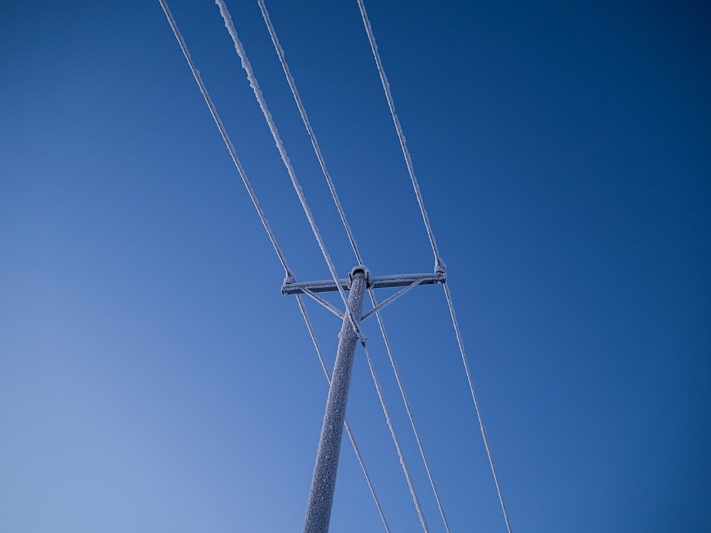 a telephone pole with a blue sky in the background