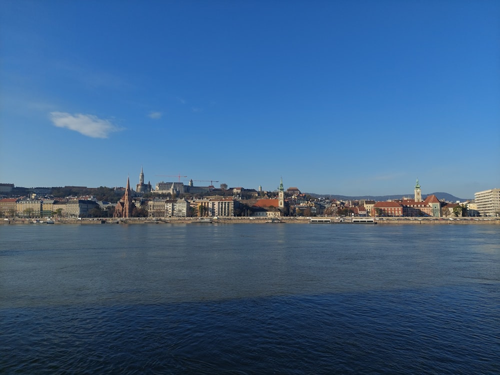 a large body of water with a city in the background