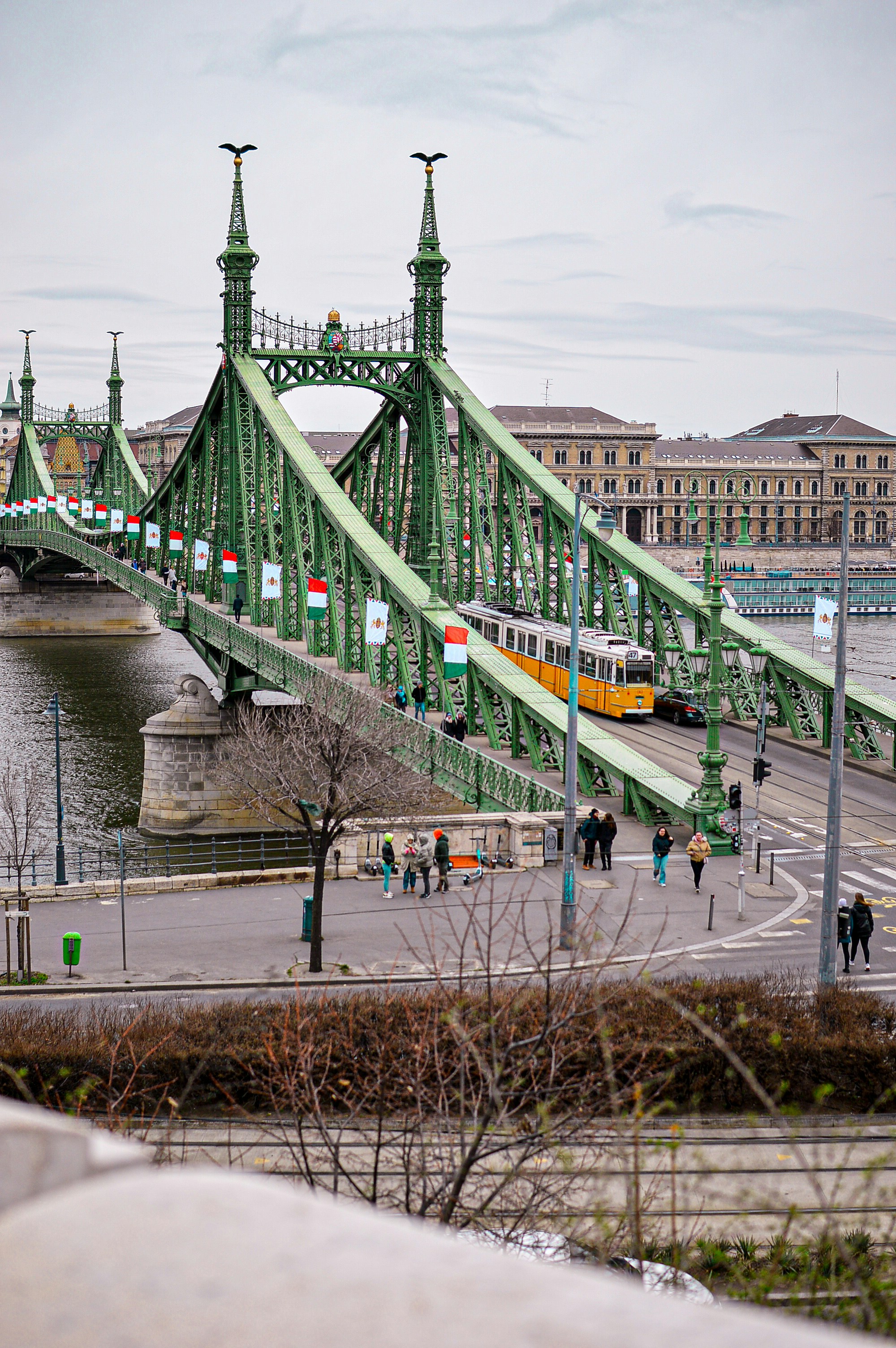 a green bridge with a train going over it