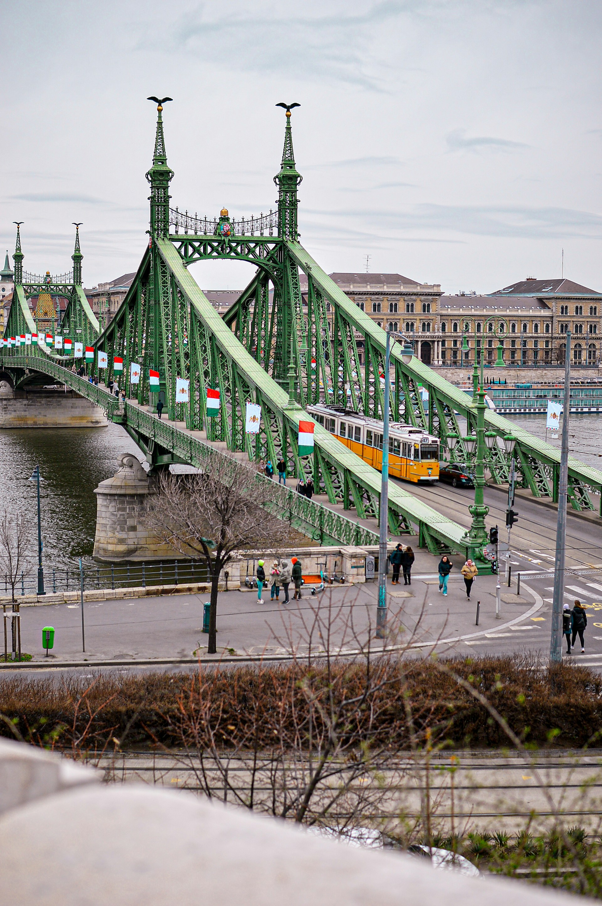 a green bridge with a train going over it