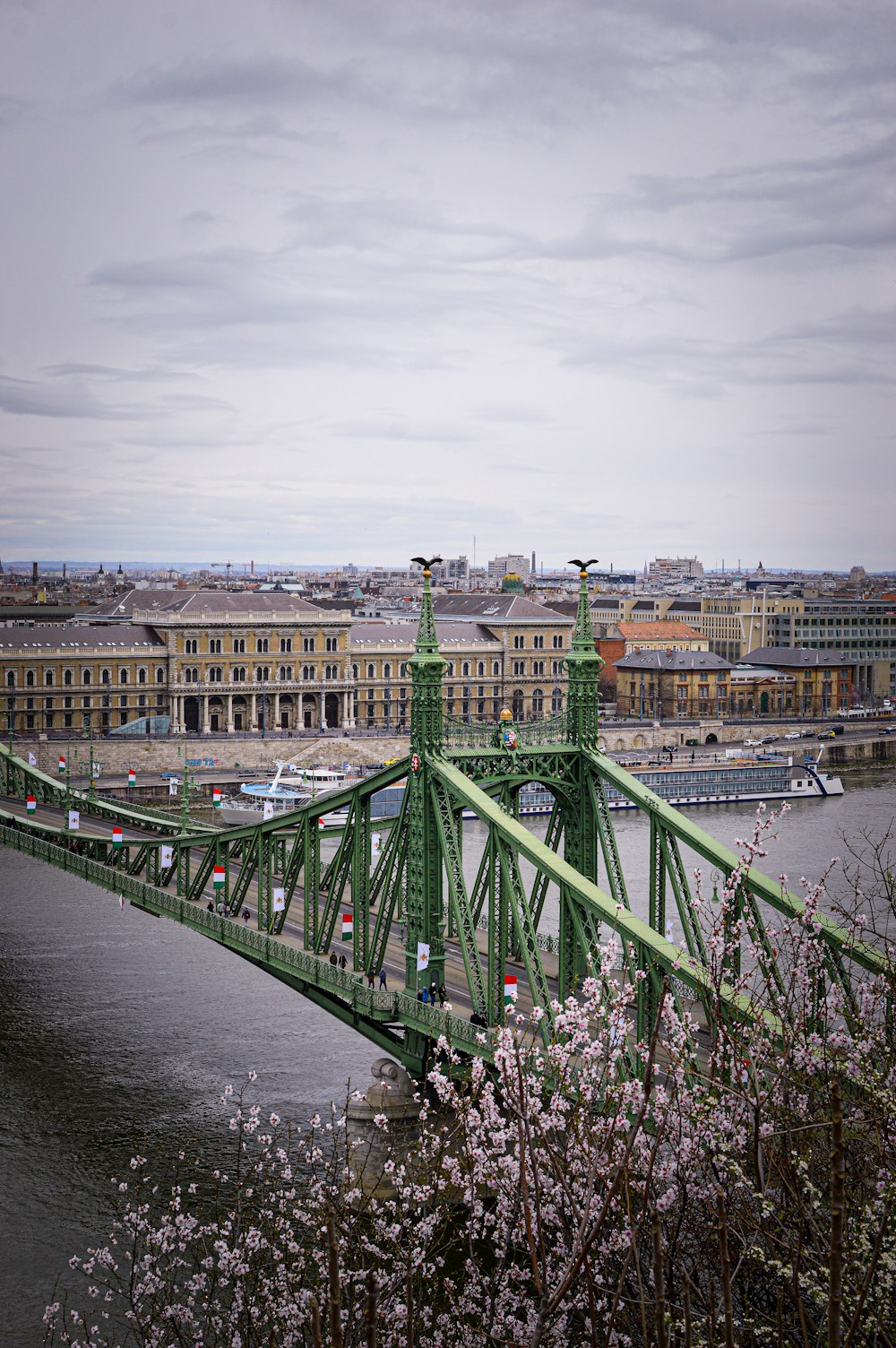 a green bridge over a body of water