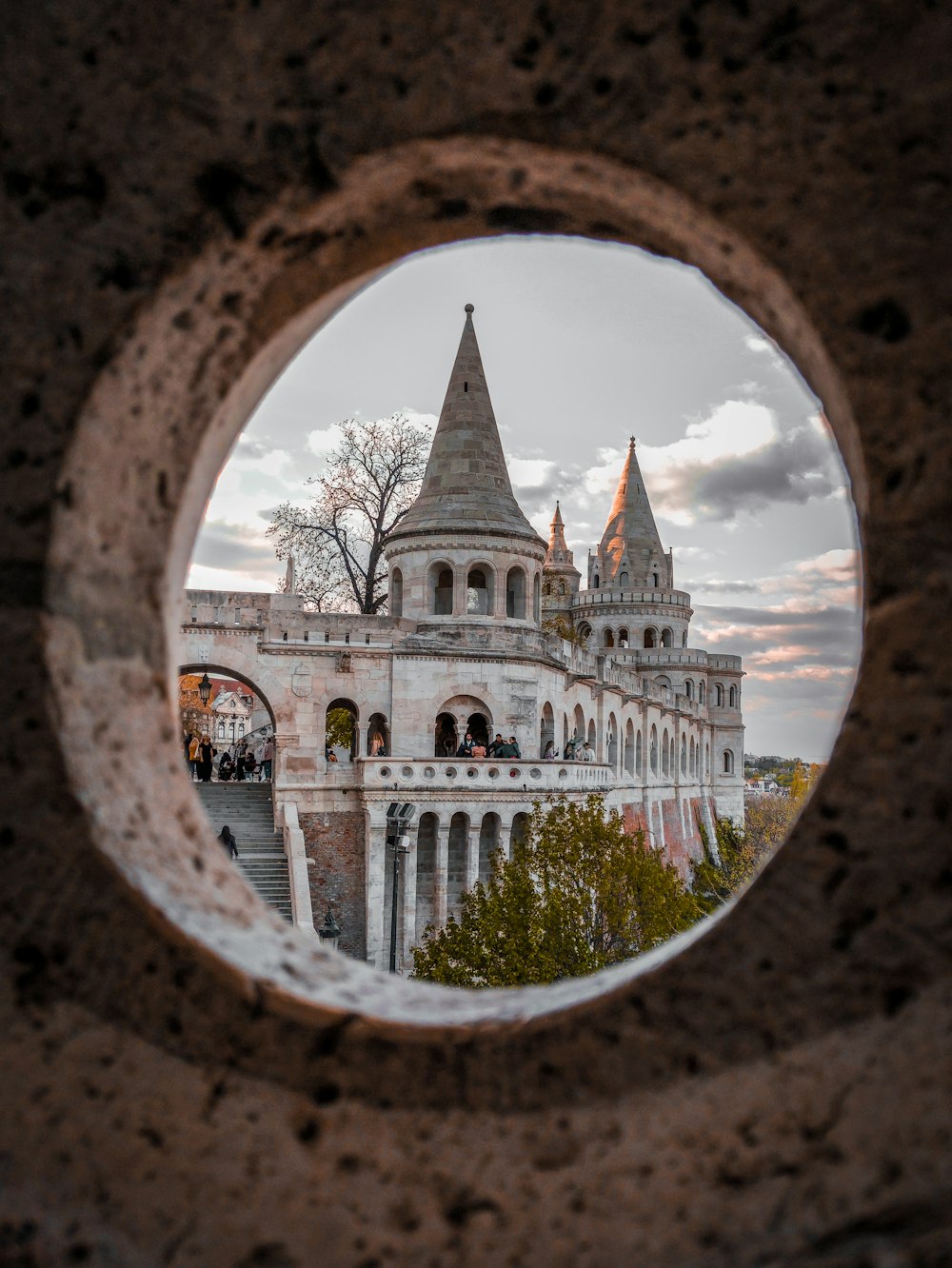 a view of a castle through a hole in a wall