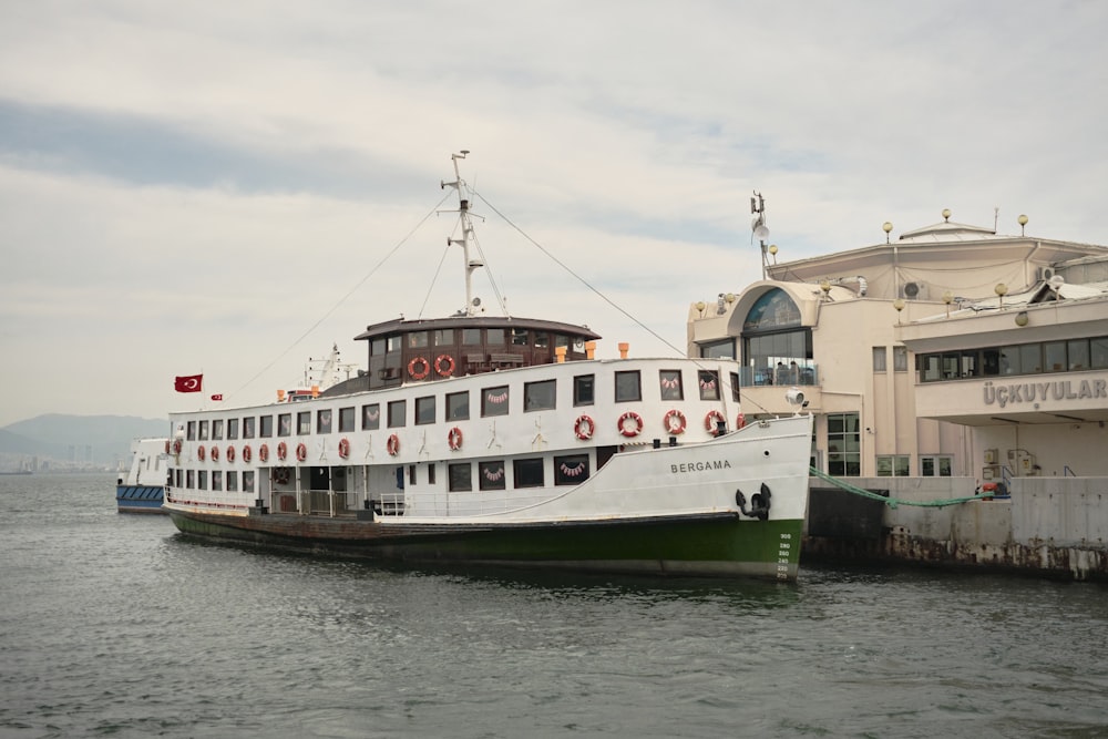 a large white and green boat in a body of water