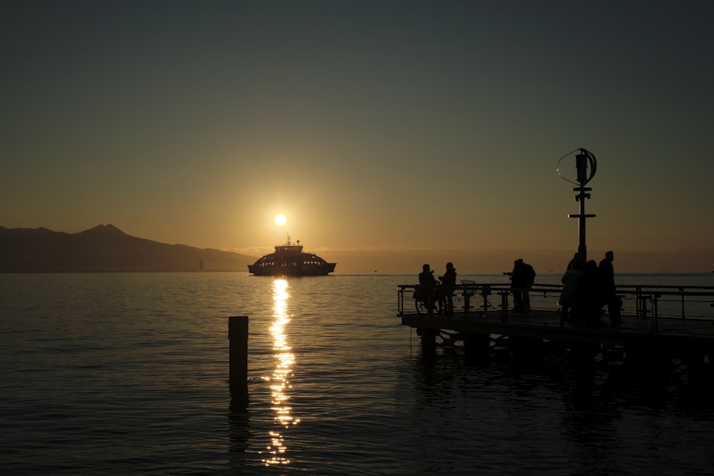 a boat is in the water at sunset