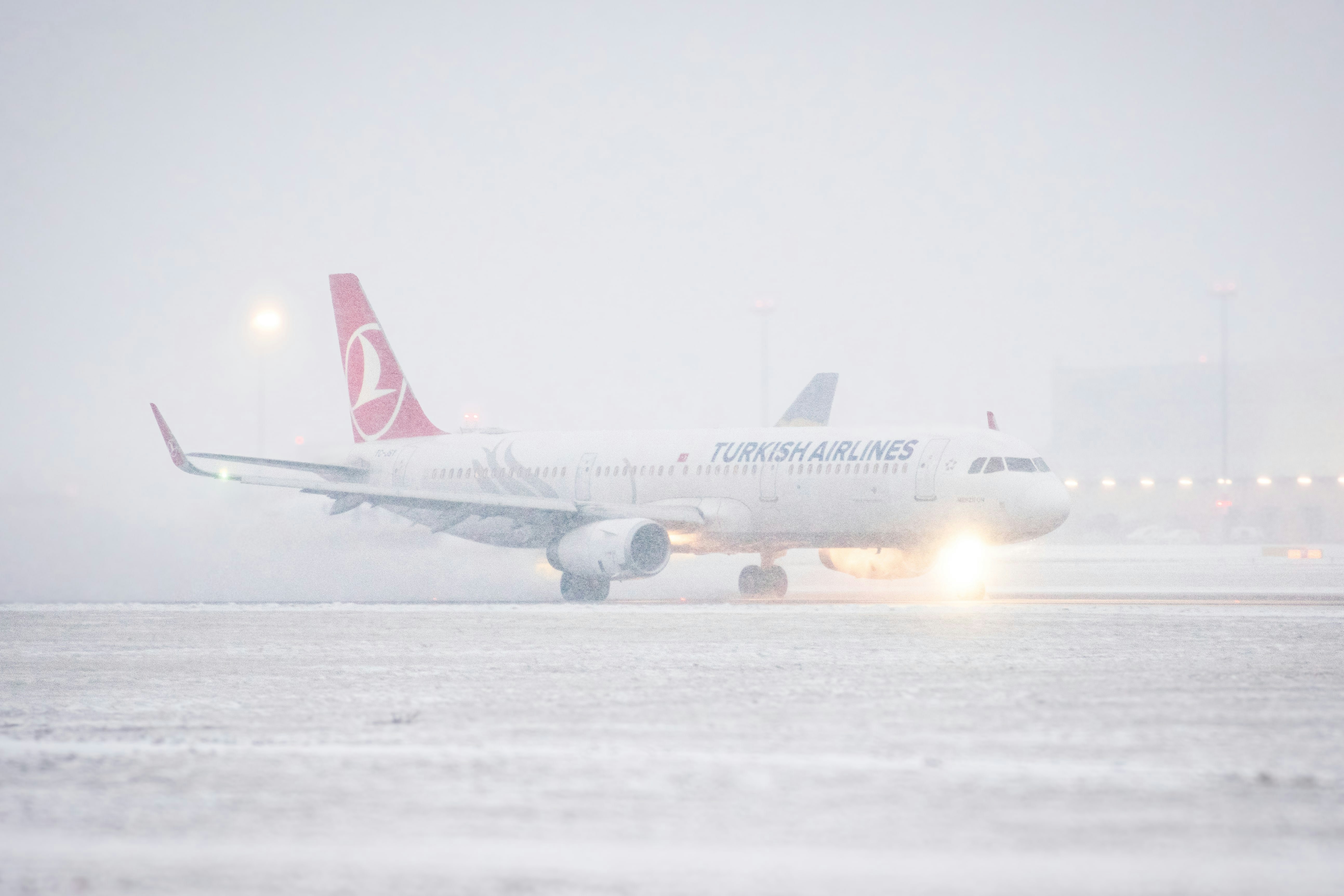 a large jetliner sitting on top of an airport runway, Turkush Airlines A321 departing from Prague