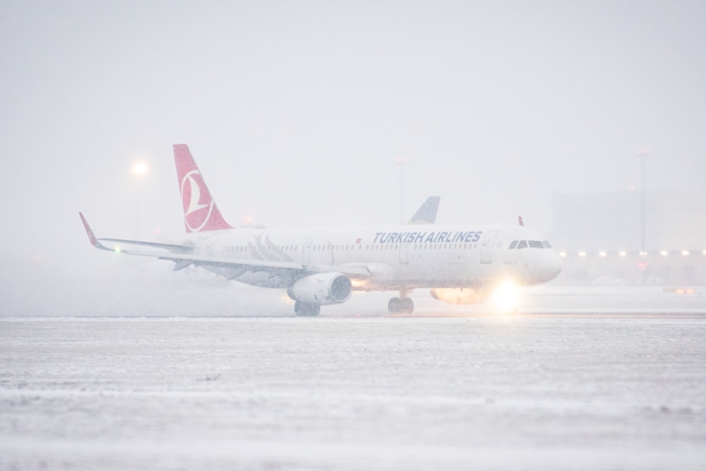 a large jetliner sitting on top of an airport runway