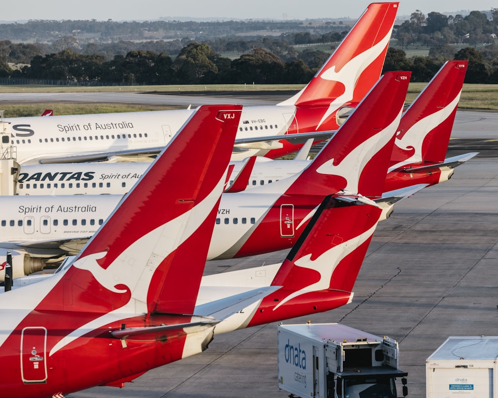 a group of airplanes that are sitting on a runway