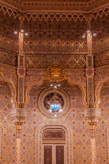 an ornately decorated building with a clock on the wall