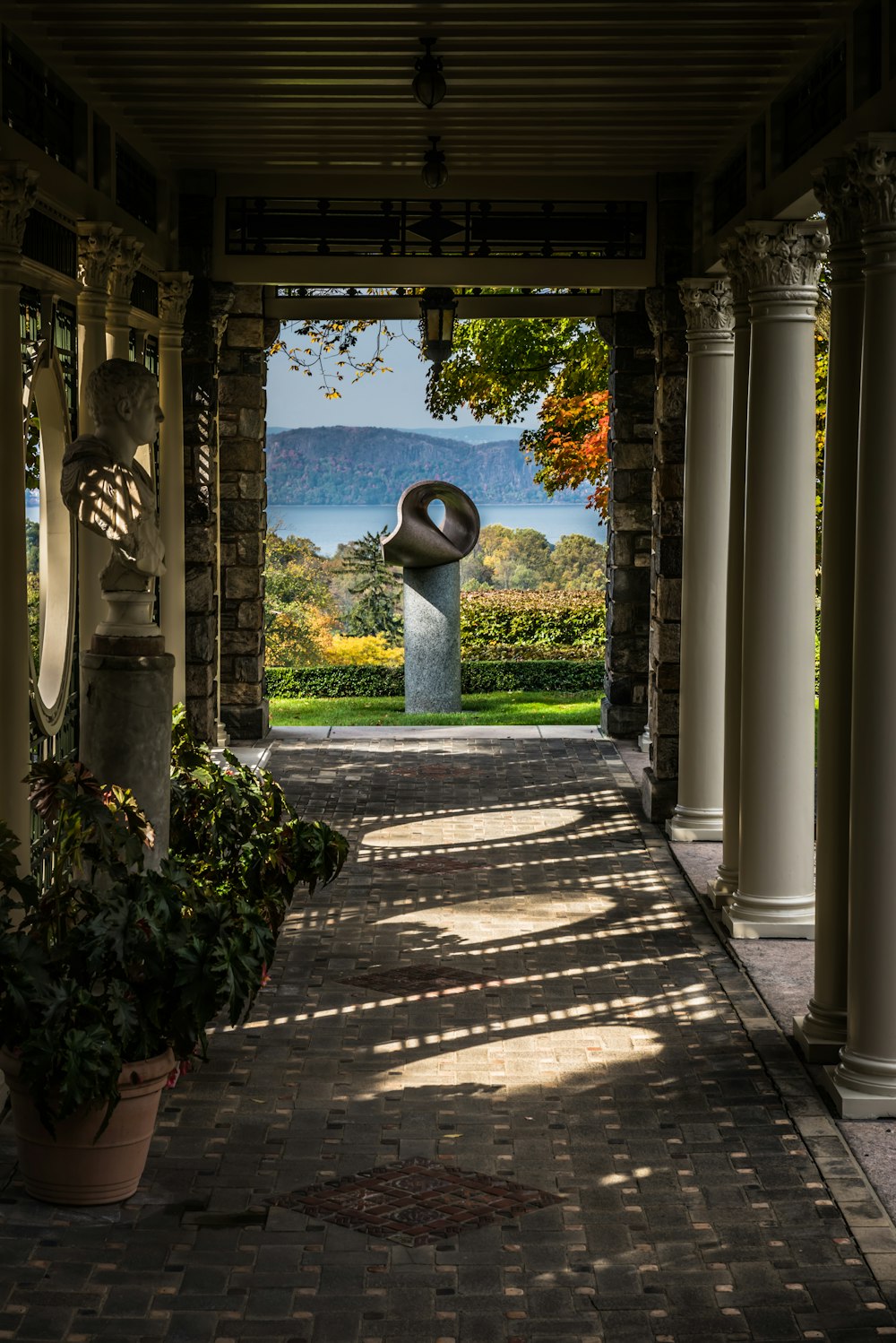 a view of a walkway with a sculpture in the background