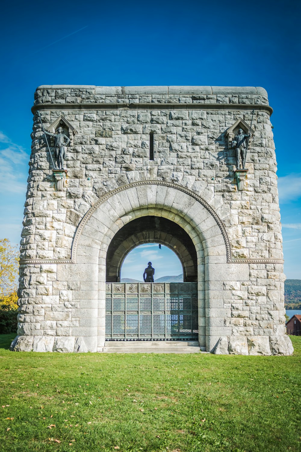 a stone archway with a clock on the top of it