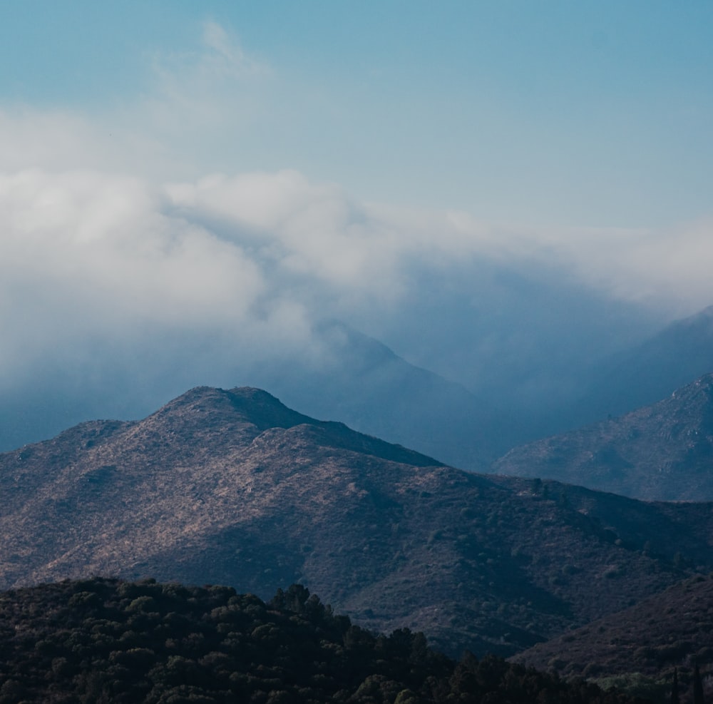 a view of a mountain range with clouds in the sky