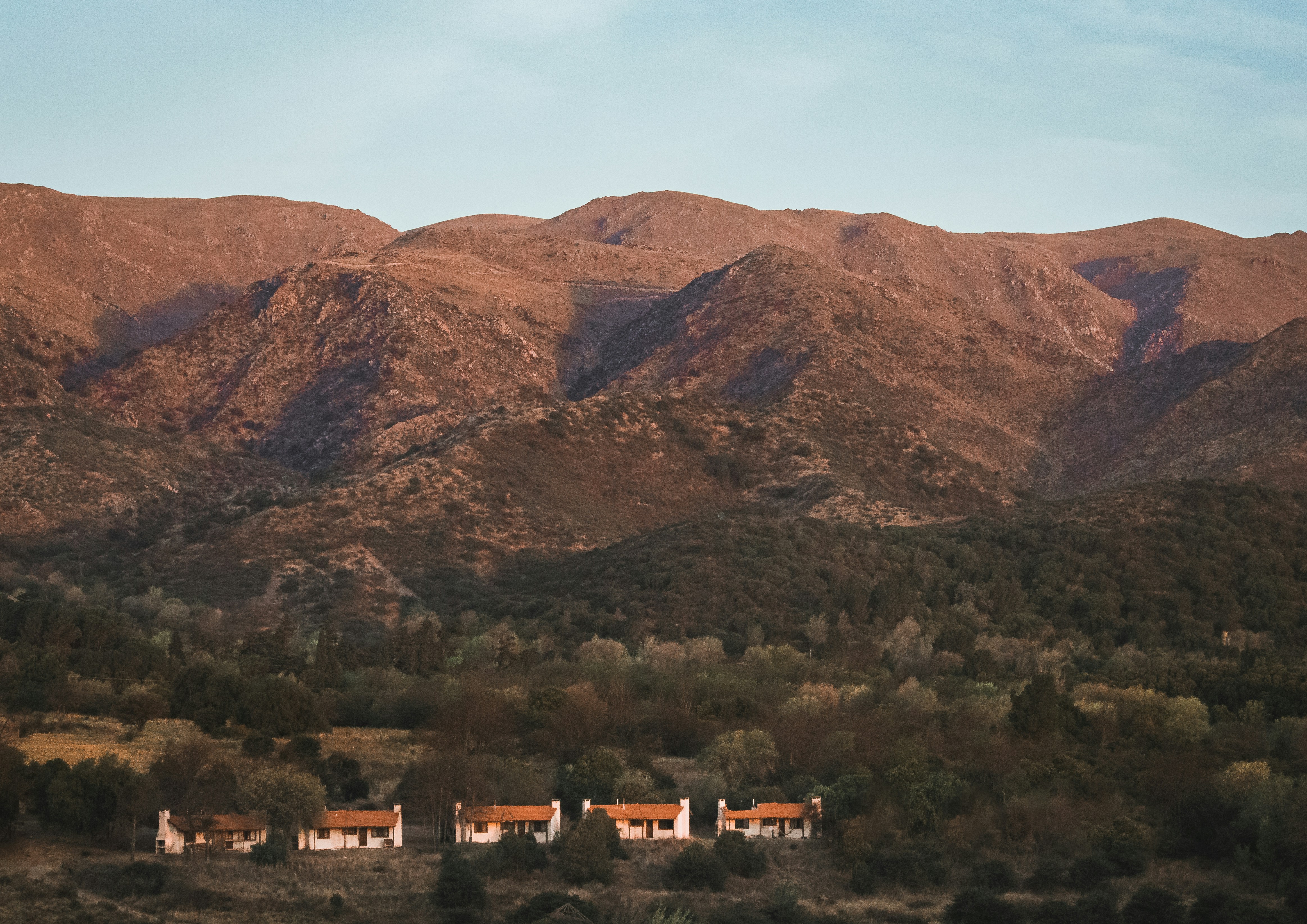 a view of a mountain range with houses in the foreground