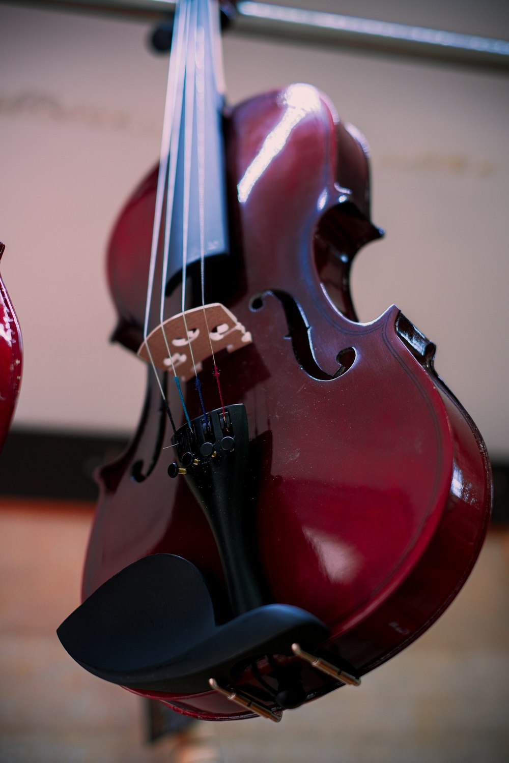 a close up of a violin hanging from a ceiling