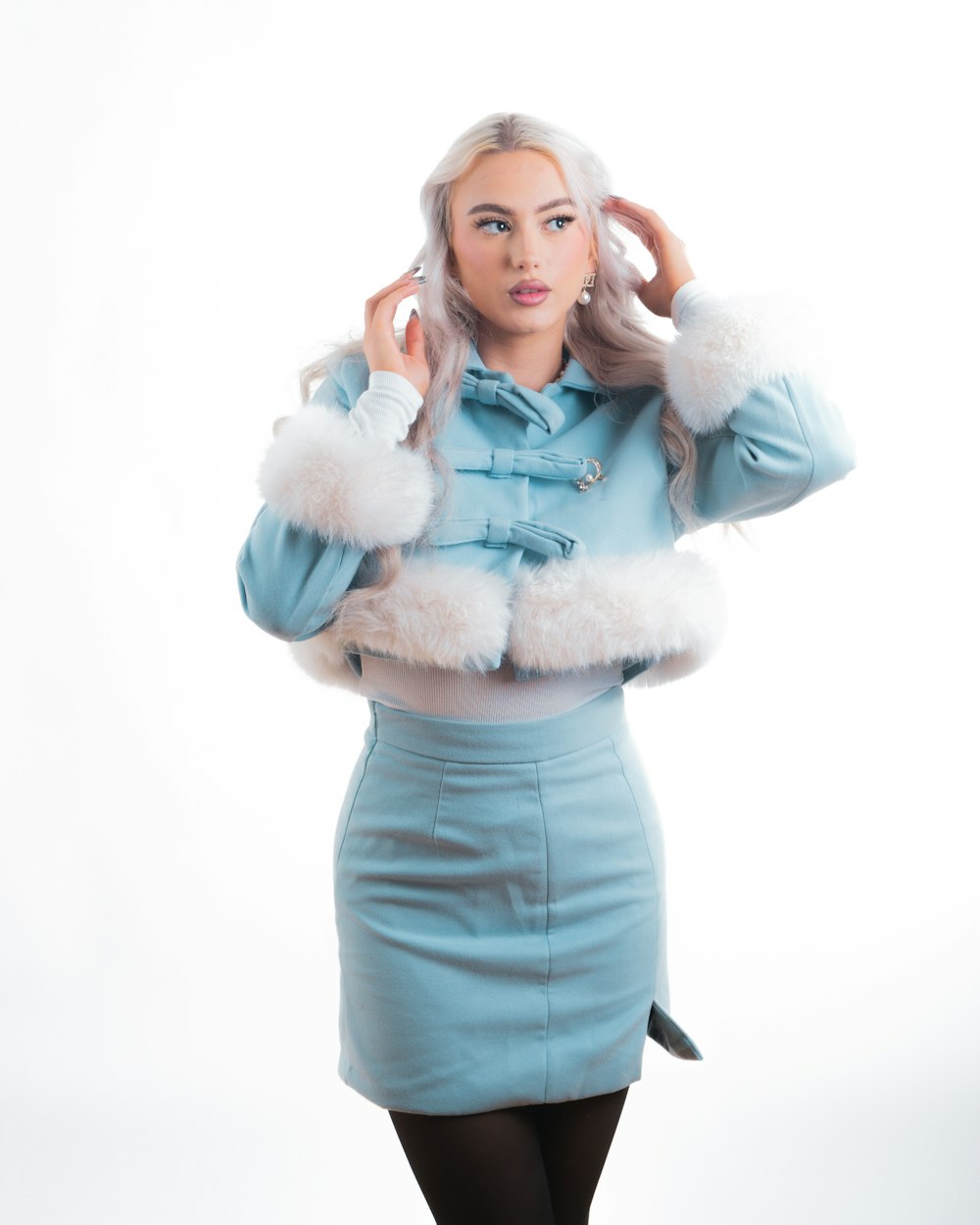 a woman in a blue dress and white fur stoler