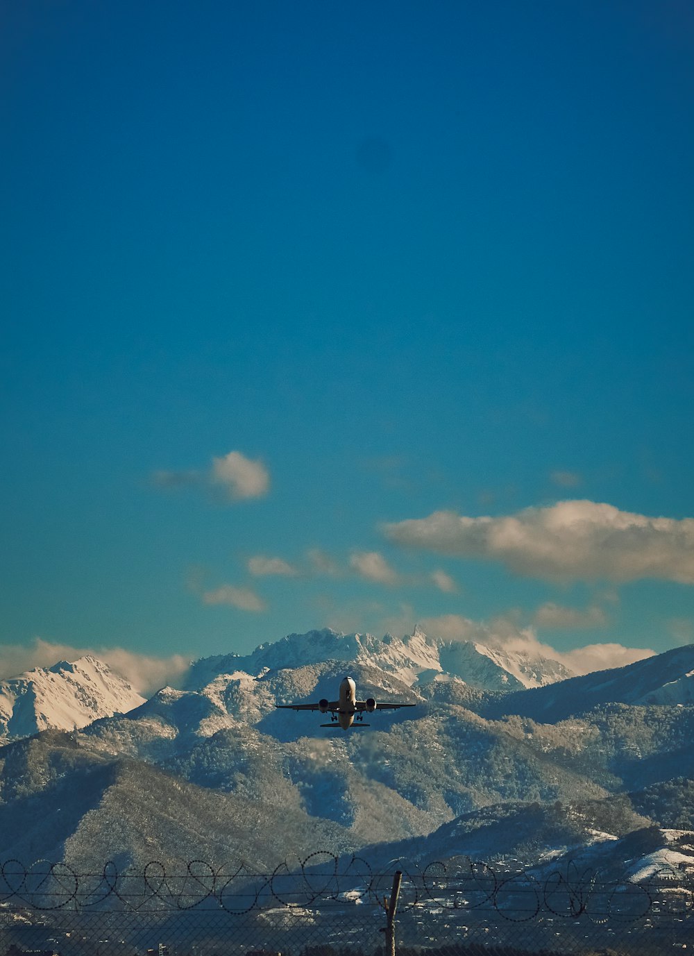 a plane is flying over a mountain range